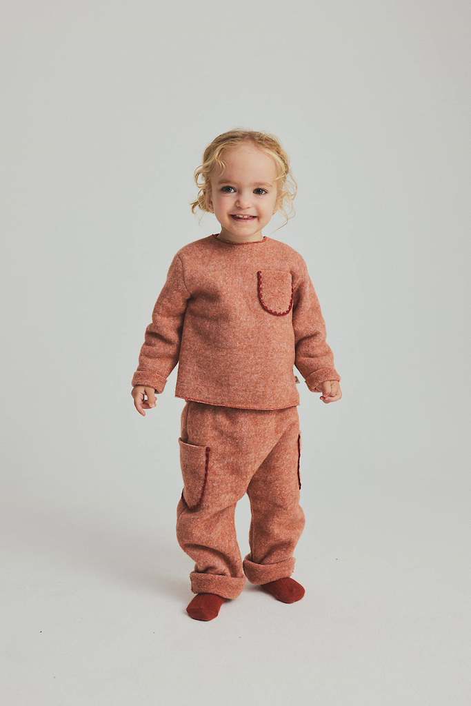 child wearing soft ginger baby set