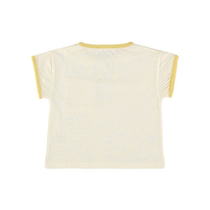 Back view of a cream-colored top with yellow trim on a white background