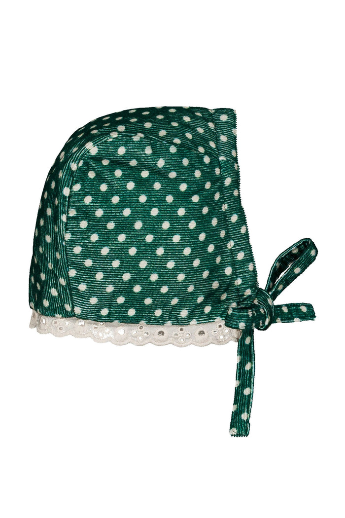 A green bonnet-style hat with white polka dots, a white lace trim along the brim, and a side tie, shown on a plain white background.