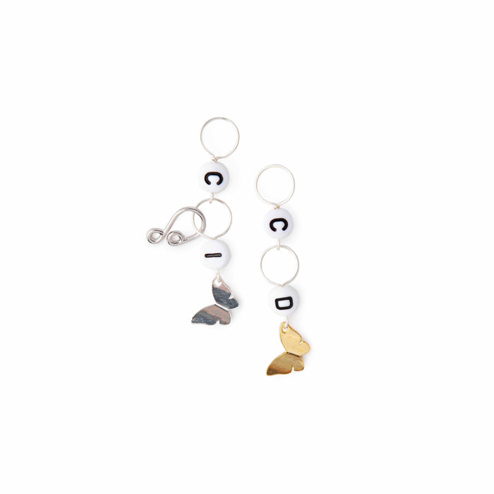 Butterfly crochet counter set laid flat showing silver increase marker with I bead and gold decrease marker with D bead