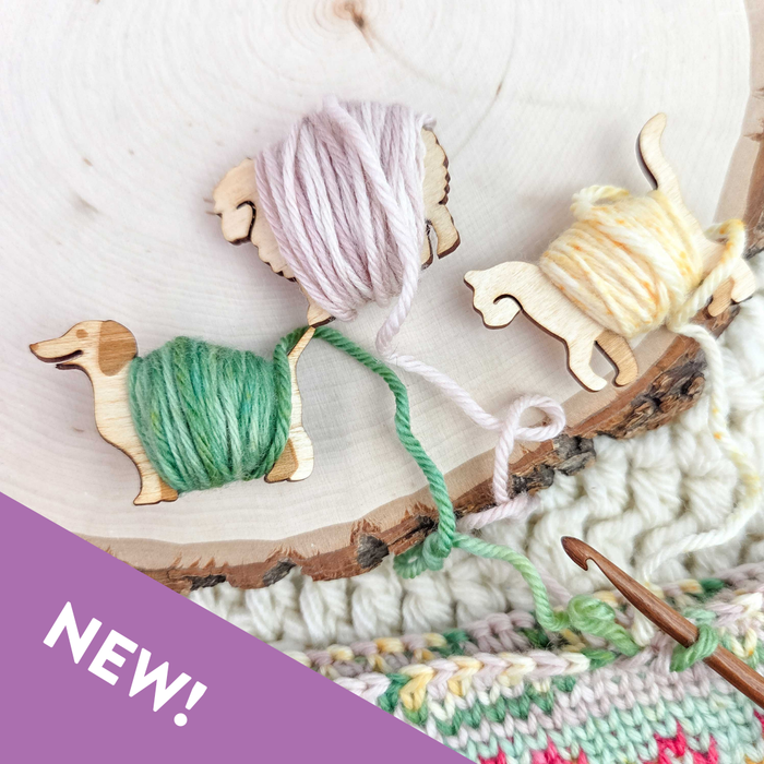 Two Little Sheep wooden yarn bobbins in sheep and llama shapes shown unwrapped on a white background displaying the laser-cut wood silhouettes