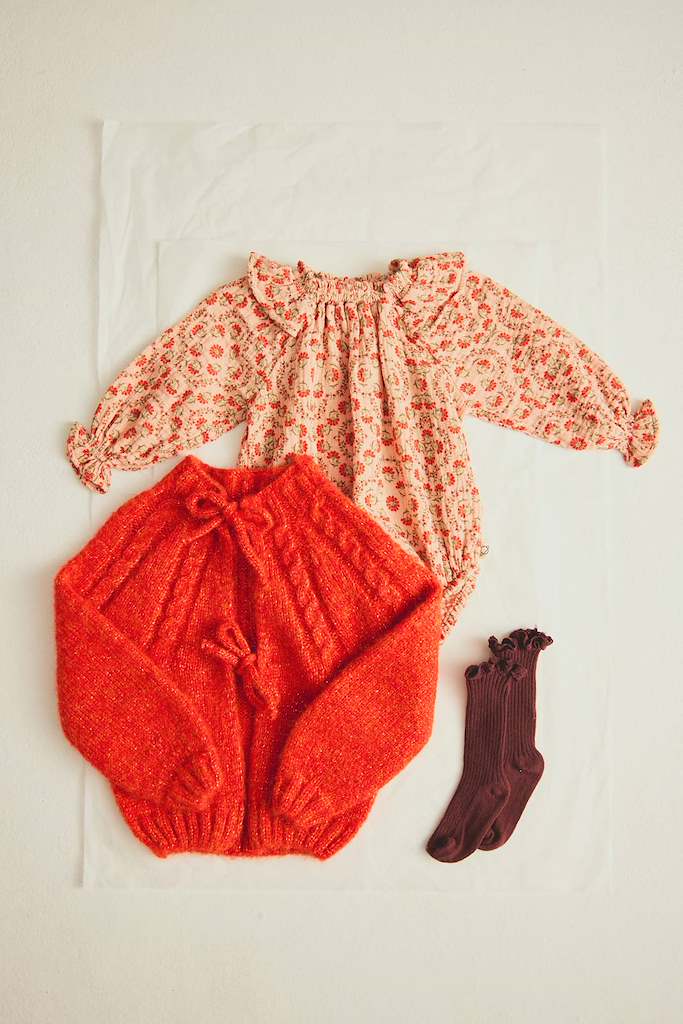 flat lay with Loira Baby Cardigan