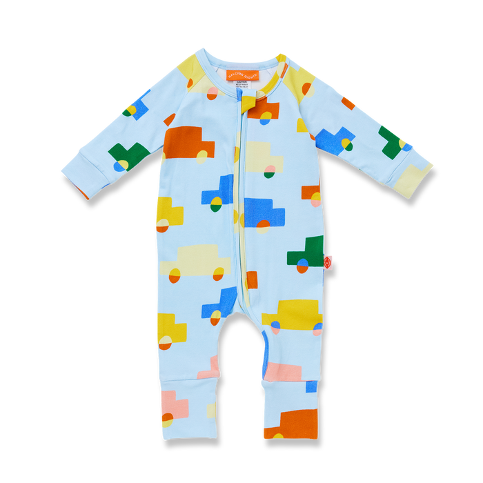 Baby onesie with colorful truck pattern on a light blue background