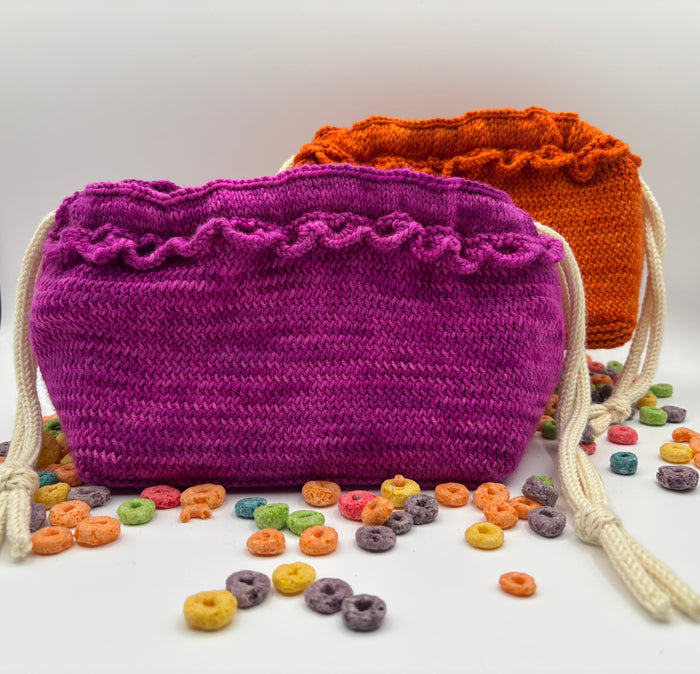 Loopdedoo Dumplin Bag knitting pattern cover showing finished orange and magenta knitted drawstring bags with the Cord Quill i-cord tool