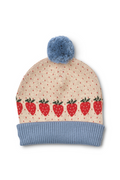 A knit beanie hat with a light blue pom-pom and ribbed cuff, featuring a cream-colored body with tiny red dots and a row of red strawberries with green tops across the front.