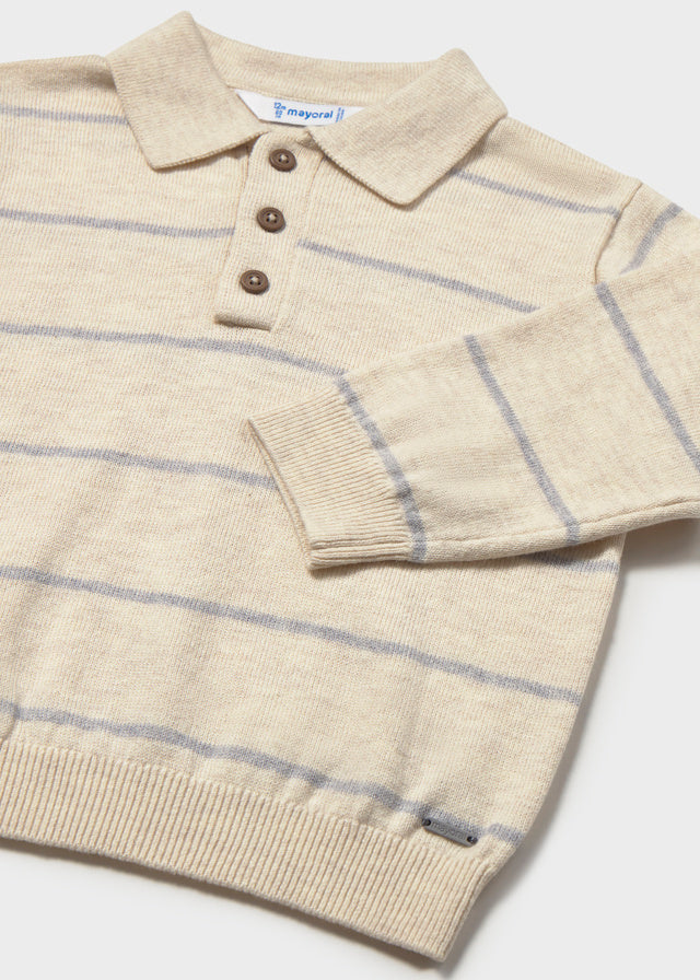 Beige and blue striped sweater with button details on a white background