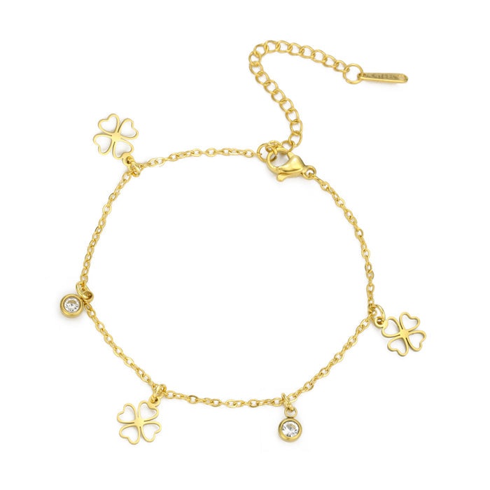 Gold chain bracelet with hanging four-leaf clover charms and sparkling round crystal accents on a white background.
