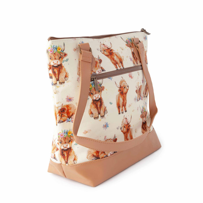 Maisy Highland Cow Mega Trinity Bag from top angle showing wide opening with leather handles and highland cow fabric