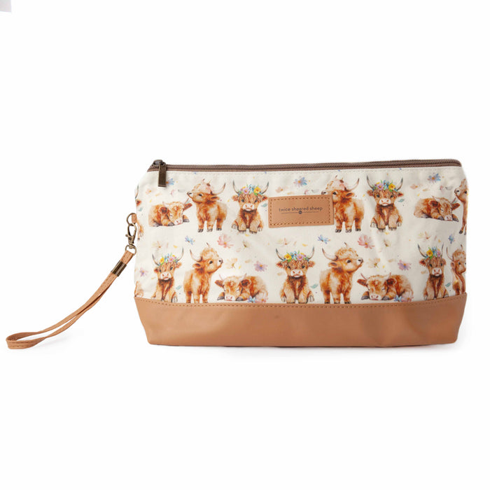 Maisy Highland Cow Trinity Bag medium zippered knitting project bag with watercolor baby highland cow illustrations wearing flower crowns on cream fabric, tan vegan leather bottom, and wrist strap