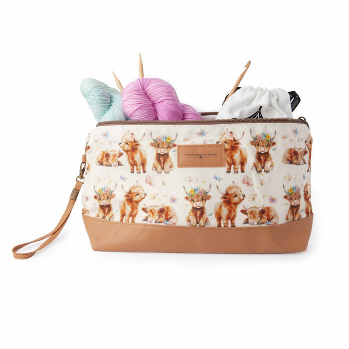 Maisy Highland Cow Trinity Bag styled with knitting supplies showing the bag in use as a project bag