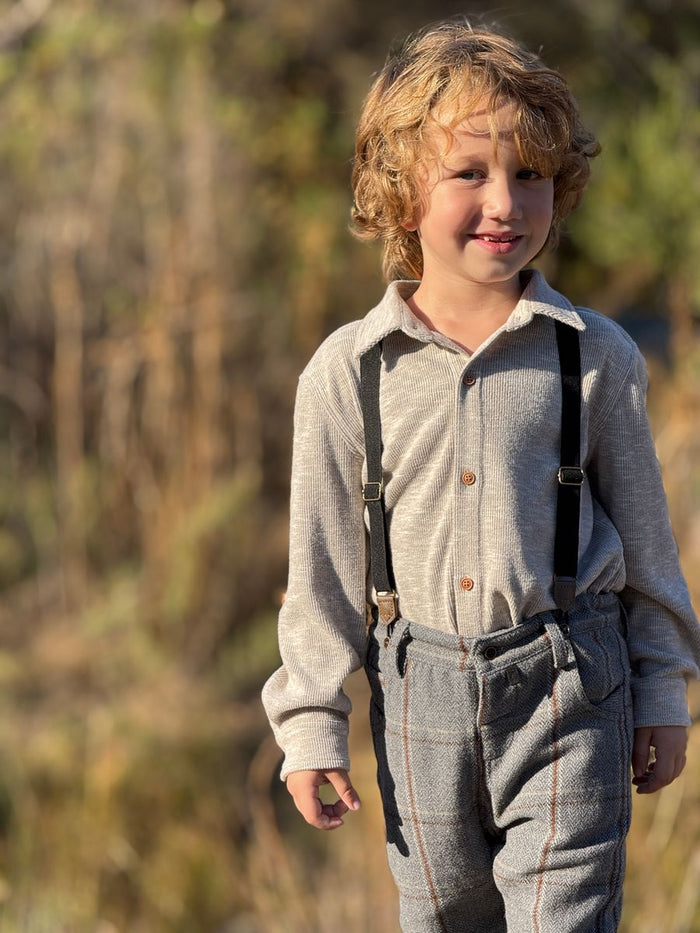 child wears pants with suspenders