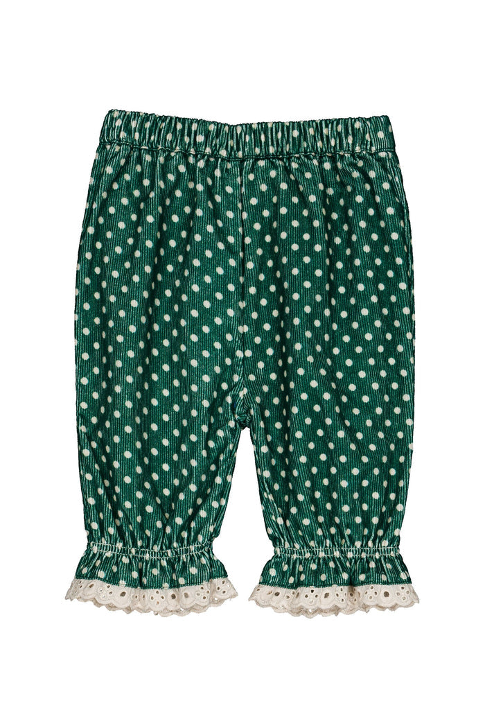 Green and white polka dot pants with a ruffled lace hem, shown flat on a white background.
