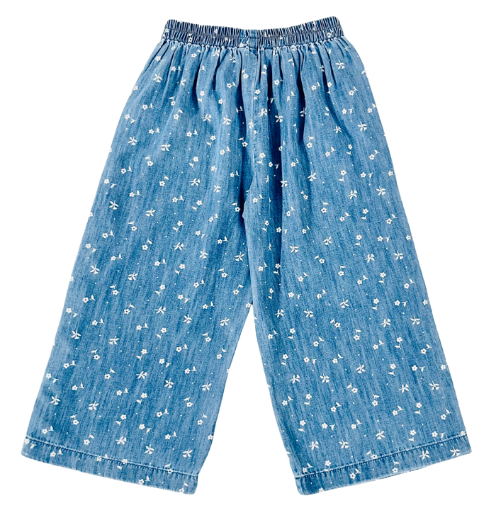 Blue denim-like wide-leg pants with an elastic waistband and a small white floral print, shown flat against a white background.