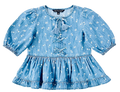 A light blue denim-like top with a white floral print, featuring puff sleeves, a tassel tie neckline, and lace-up front detailing.