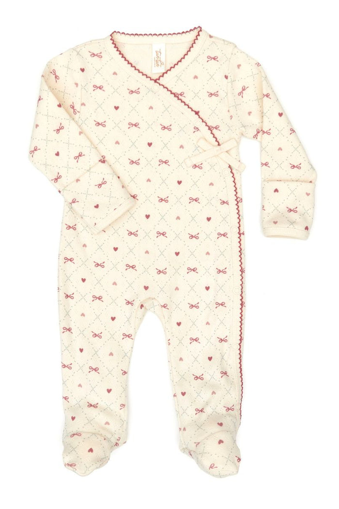 Baby onesie with bow pattern on a white background