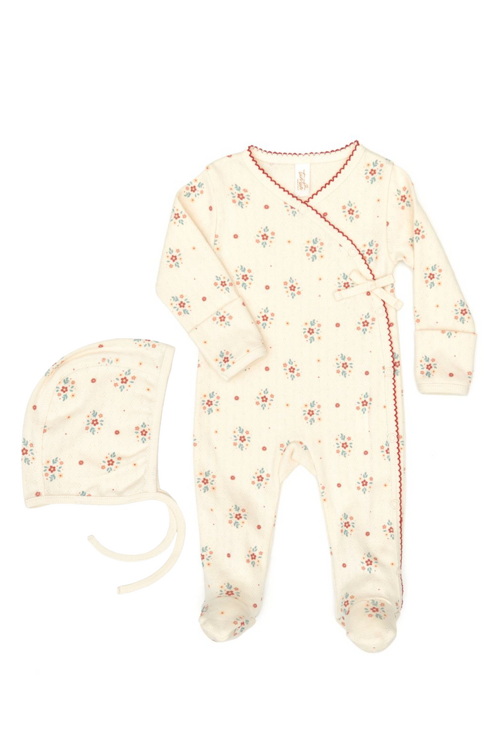 Baby onesie and hat with floral pattern on a white background