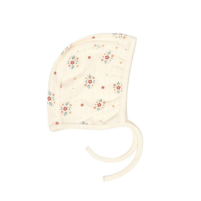 Floral-patterned baby bonnet on a white background
