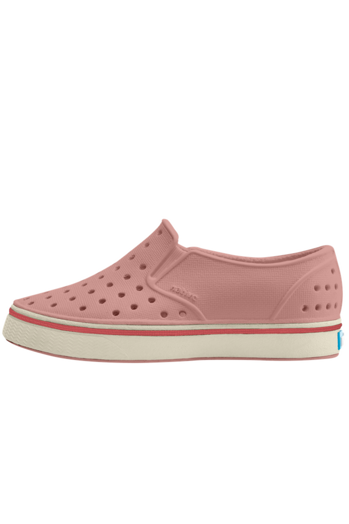 Pink slip-on shoe with a white sole on a white background