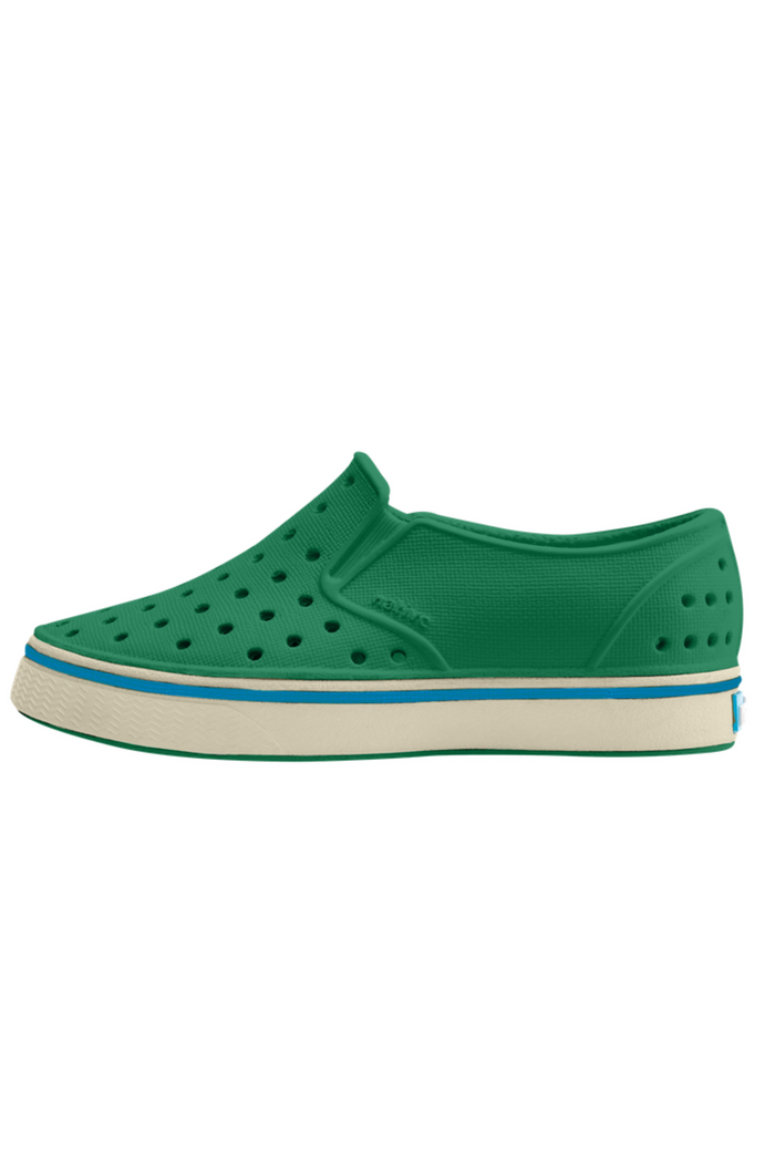 Green slip-on shoe with white sole on a white background