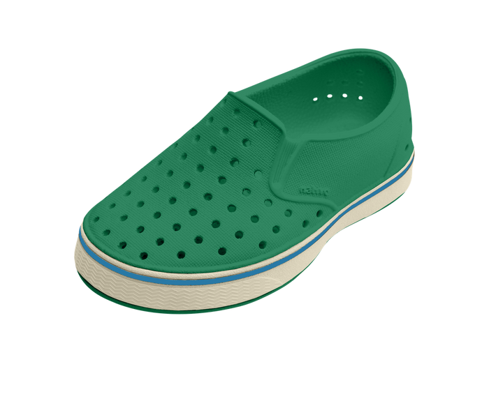 Green shoe with a white sole on a transparent background