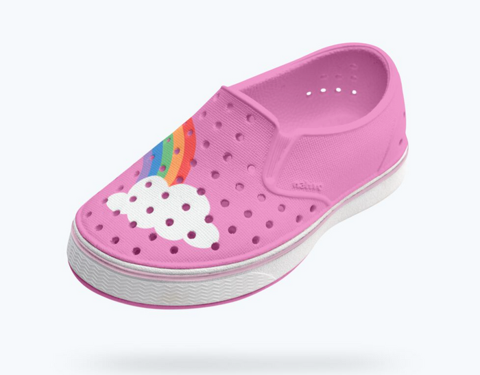 Pink clog shoe with a rainbow and cloud design on a white background