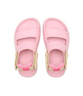 Pair of pink sandals with beige straps on a white background