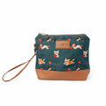 Cats and Dogs Mini Trini Bag small zippered sock project bag with teal fabric featuring playful kittens, corgis, and beagles chasing red yarn balls, tan vegan leather bottom, and wrist strap