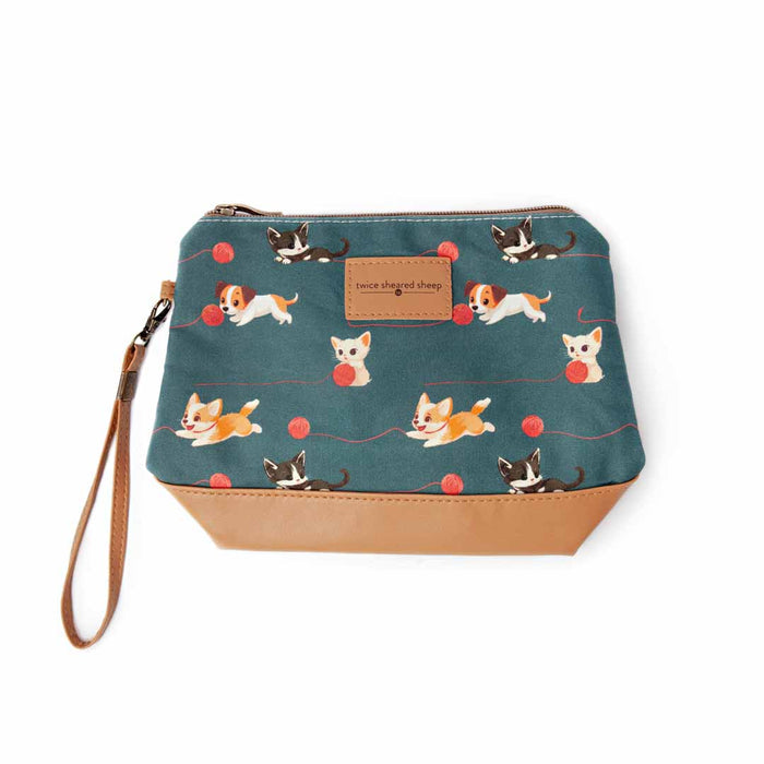 Cats and Dogs Mini Trini Bag top-down view showing the teal fabric with playful cats and dogs pattern, tan vegan leather bottom, and wrist strap