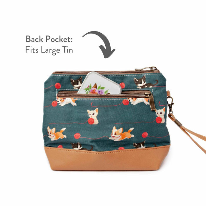 Cats and Dogs Mini Trini Bag back view showing the zippered exterior pocket partially open with a storage tin visible and annotated text reading Back Pocket Fits Large Tin