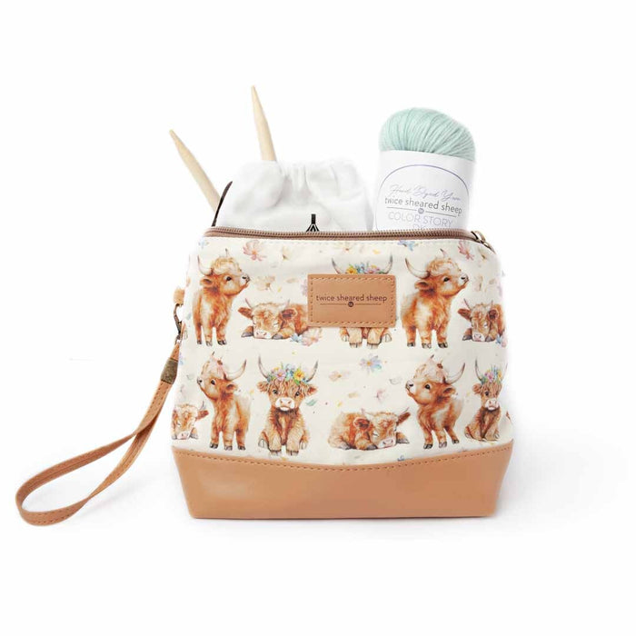 Maisy the Highland Cow Mini Trini Bag filled with a mint yarn ball, TSS Color Story yarn skein, and bamboo knitting needles showing the compact storage capacity