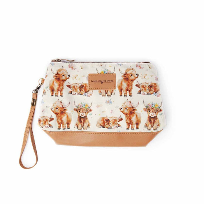 Maisy the Highland Cow Mini Trini Bag top-down view showing the cream fabric with watercolor highland cow pattern, tan vegan leather bottom, and wrist strap