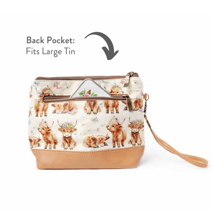 Maisy the Highland Cow Mini Trini Bag back view showing the zippered exterior pocket partially open with a storage tin visible and annotated text reading Back Pocket Fits Large Tin