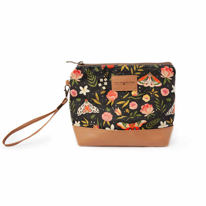 Night Forest Mini Trini Bag small zippered sock project bag with dark navy moth and floral print, tan vegan leather bottom, and wrist strap