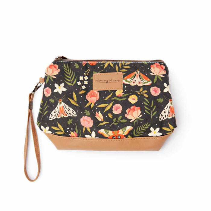 Night Forest Mini Trini Bag from above showing the dark navy moth and floral print fabric with tan vegan leather bottom and wrist strap