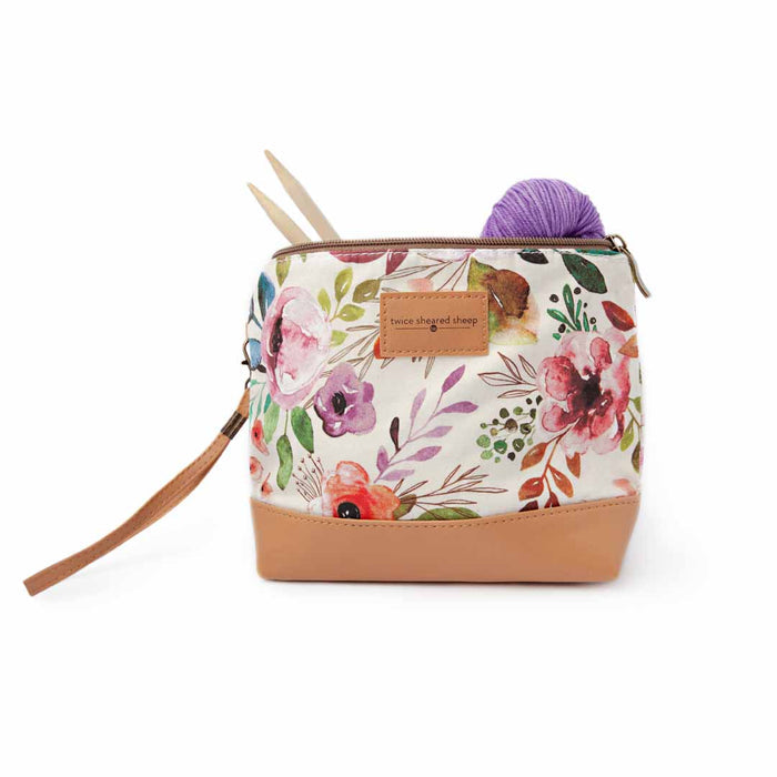 Spring Floral Mini Trini Bag filled with a purple yarn ball and bamboo knitting needles showing the compact storage capacity of the small zippered project bag