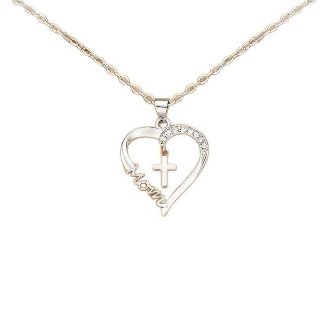 A two-tone heart pendant necklace on a rose gold chain. The open heart pendant features a silver-toned side pavé-set with clear crystals and a rose gold-toned side with the word "Mom" engraved in a flowing script. A small silver-toned cross hangs within the center of the heart. The jewelry is shown against a plain white background.