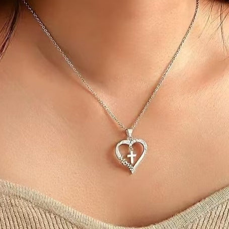 Minimalist silver-tone heart-shaped cross pendant necklace on an O-ring chain, unisex aesthetic jewelry.