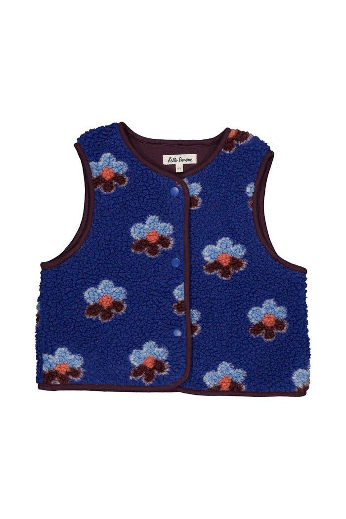 A sleeveless blue fleece vest with a floral pattern of light blue, dark brown, and orange flowers, featuring dark brown trim and a front zipper.