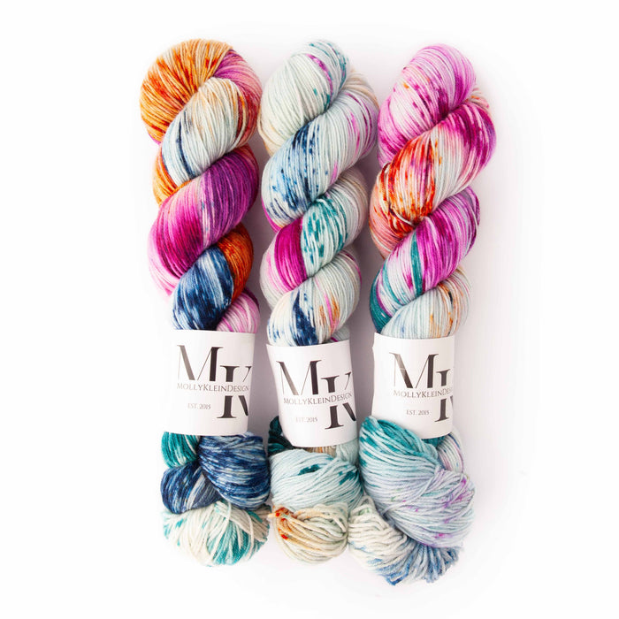 All dye lots of Molly Klein Design Sweet Sock Mermaid colorway displayed together on white background, showing natural variation across multiple skeins