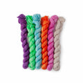 Six mini yarn skeins in purple, green, blue, orange, pink, and cream Dino Disco colorway
