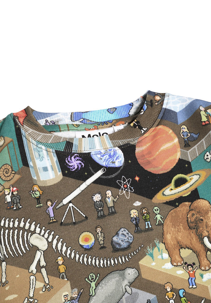 Children's shirt with a colorful design of animals, planets, and people in a museum setting.