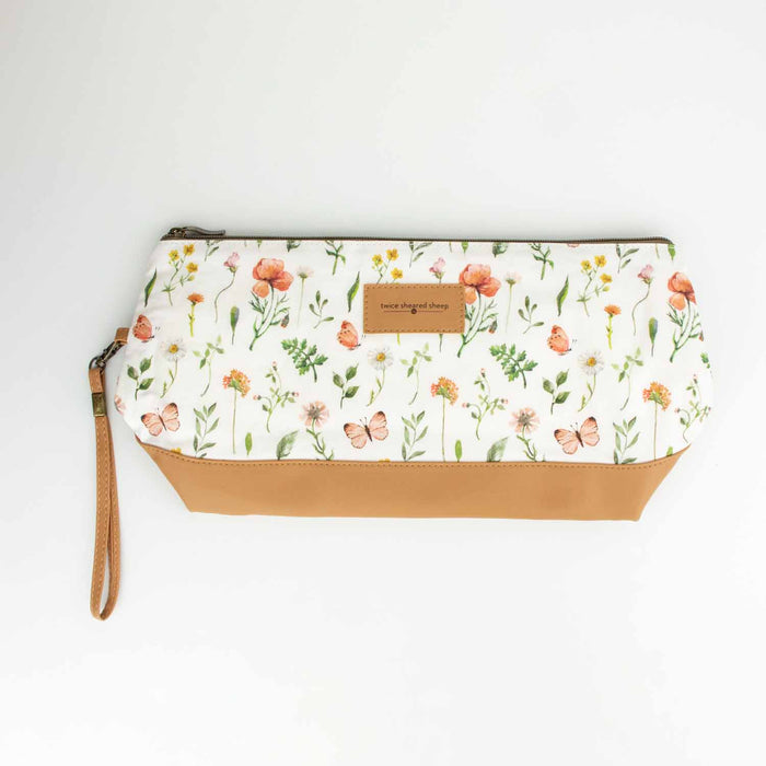 Mountain Meadow Trinity Bag with two skeins of mauve yarn and bamboo knitting needles tucked inside to show capacity