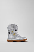 silver cowboy boot with gold and black stars on grey background.