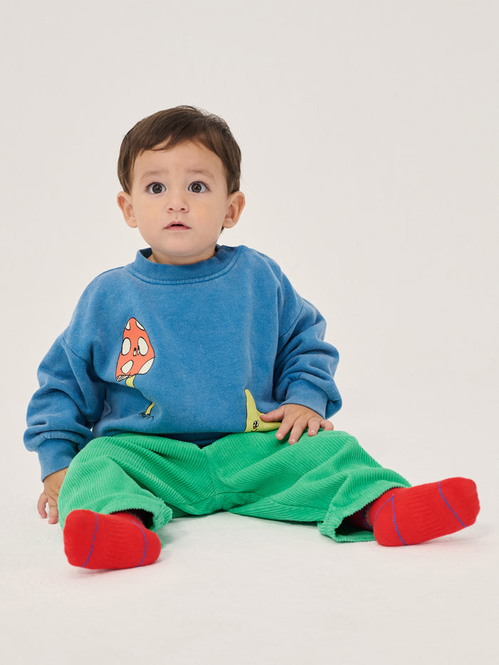Child wearing green trousers