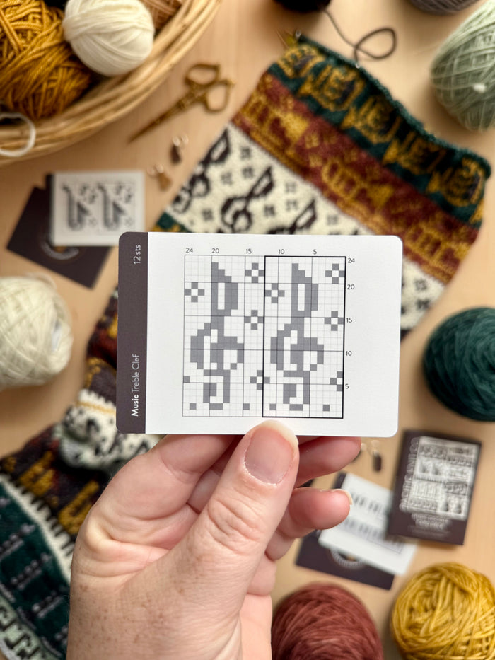 Hand holding a Music Doodle treble clef colorwork chart card