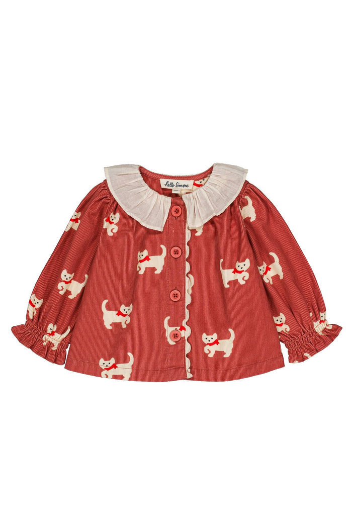 A toddler's long-sleeve button-up blouse in terracotta red with a cream-colored cat print and a cream ruffled Peter Pan collar, shown flat on a white background.