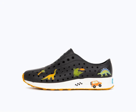 Black shoe with dinosaur illustrations on a white background