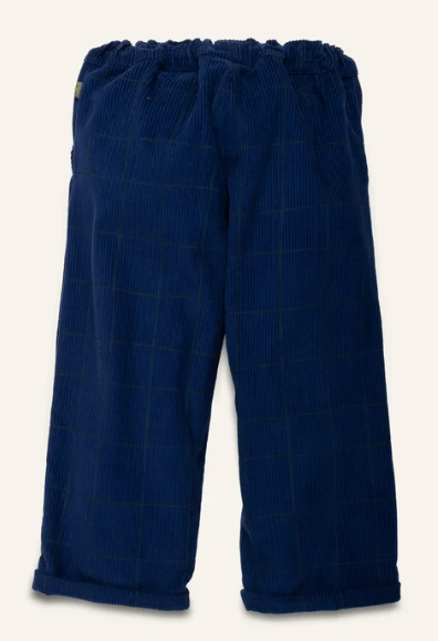 A pair of dark blue corduroy trousers with a subtle windowpane check pattern, featuring an elastic waistband and rolled cuffs, shown against a light cream background.