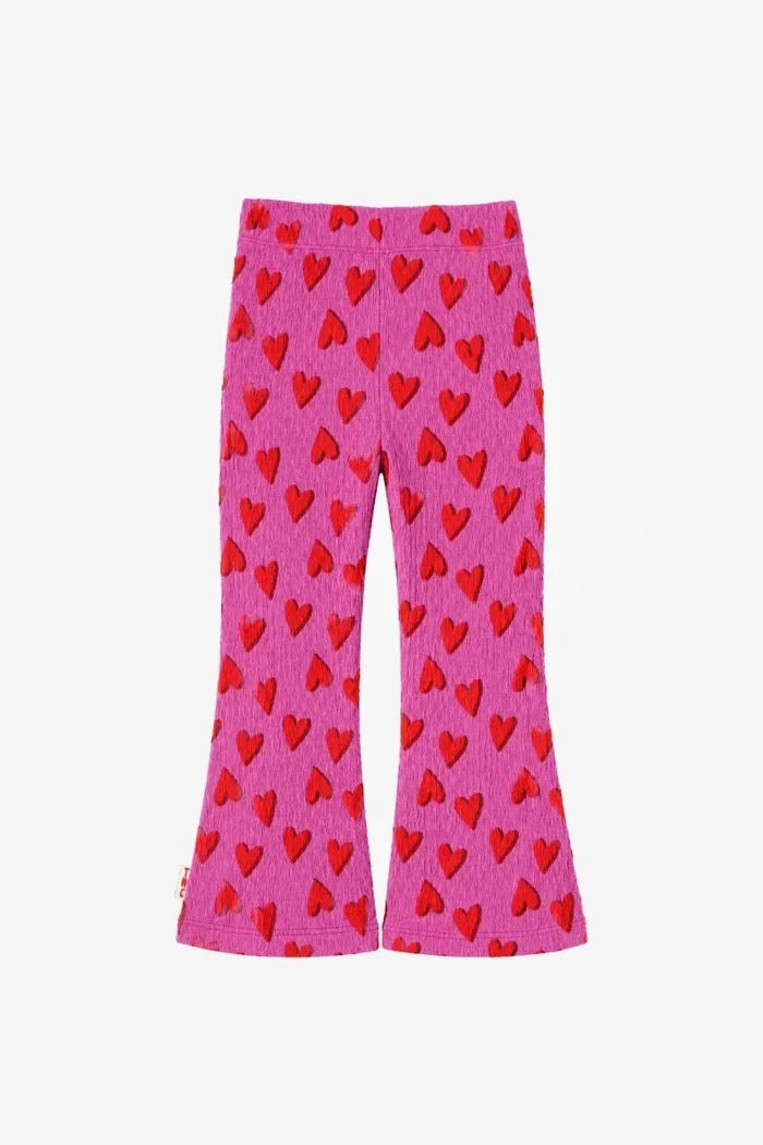 fuchsia flared leggings with red hearts all over on white background