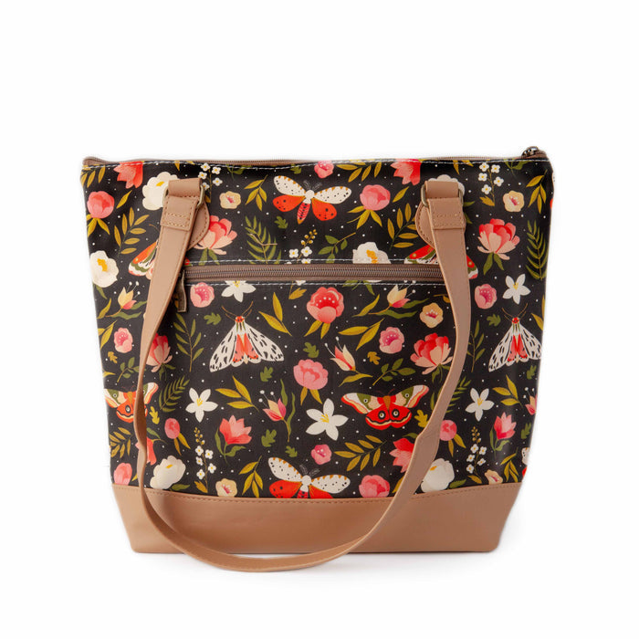 Night Forest Mega Trinity Bag back view showing the zippered exterior pocket with the same dark floral and moth print and tan vegan leather shoulder strap draped down